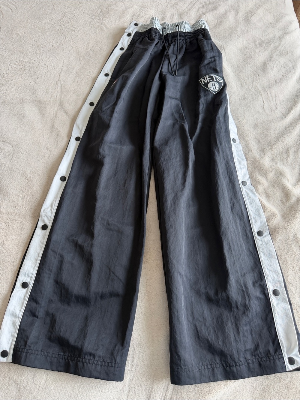 Nike Black Track Pants with White Snap Side Stripes and Nets Patch